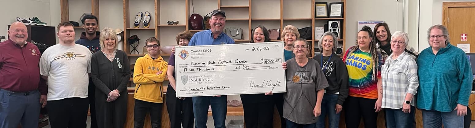Volunteer_05-min people holding large check with group of people